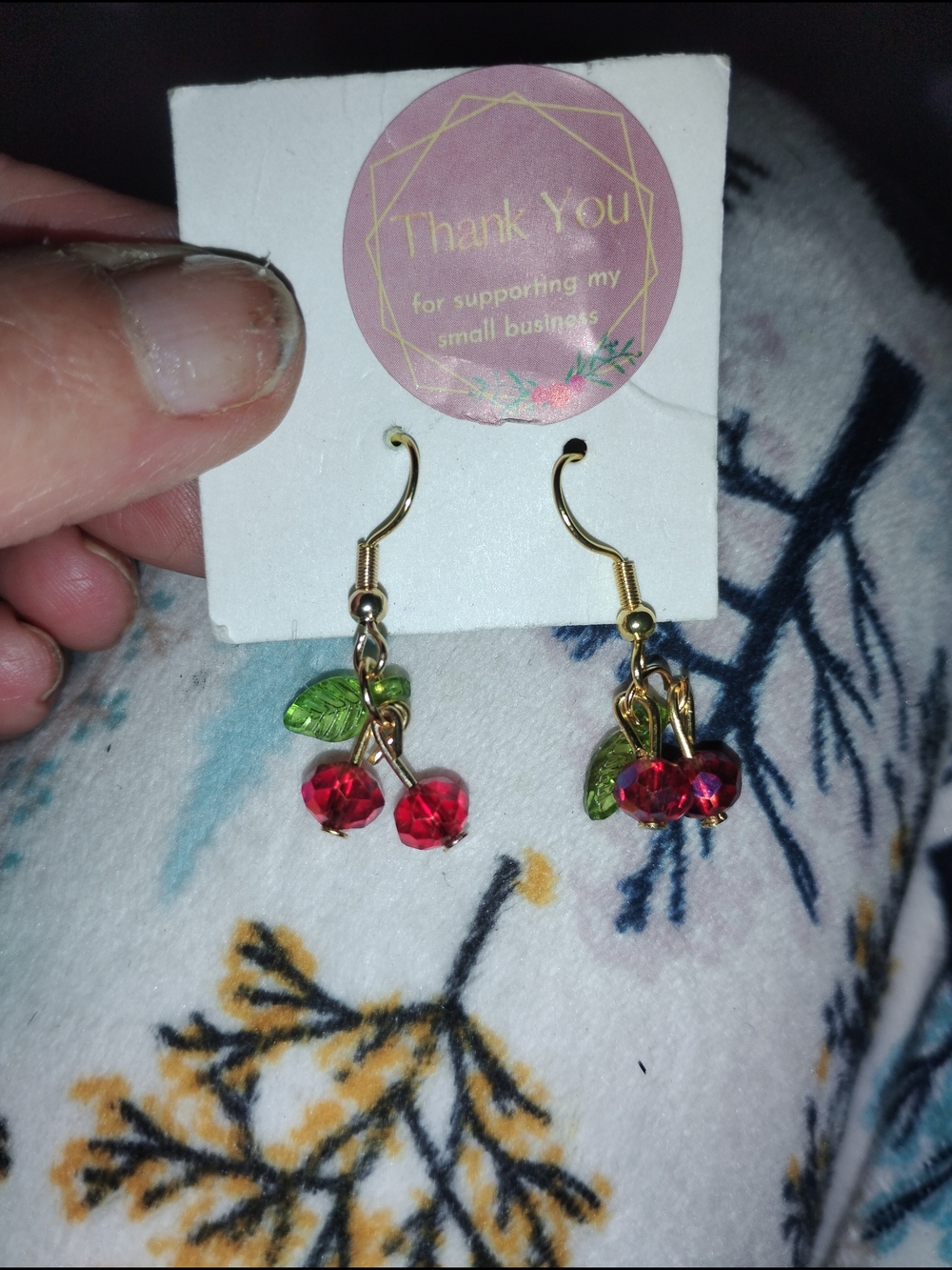 Gold toned CherryBomb Dangle Earrings with Red Glass Beads and Green Leaves